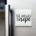 A white refrigerator magnet with the text "THE ANSWER IS NOPE" printed on it.