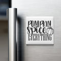 a refrigerator with a white magnet that says "Pumpkin spice everything" in black text.