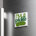 A white refrigerator magnet with a green pickle on it, displaying the text "I'm a pickle" in a playful, cartoonish font.
