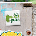 a sticker with the text "Pickle queen" and a cartoon image of a pickle wearing a crown.